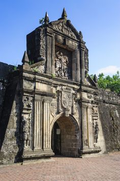 an old building with a clock tower on the side of it's front door