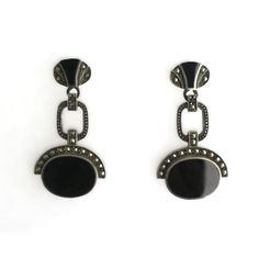 This is part of Chairish’s Fine Jewelry assortment.  A beautiful pair of black onyx and sterling silver Art Deco style dangle earrings, circa mid to late-20th century. A great pair to dress up or down. Each are marked on back 'Sterling' as shown in last three images. Excellent condition as shown in images. No issues. Dimensions: 1.5" Long. Classic Black Enamel Sterling Silver Earrings, Classic Sterling Silver Earrings With Black Enamel, Black Art Deco Earrings For Evening, Classic Onyx Earrings For Evening, Black Polished Evening Earrings, Black Polished Finish Earrings For Evening, Onyx Earrings For Evening, Black Polished Earrings For Evening, Formal Pierced Onyx Earrings