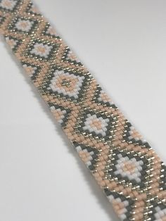 a beaded bracelet is shown on a white surface