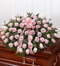 The ultimate symbol of grace, love and admiration, soft pink roses are a sentimental way to honor someone who was deeply cherished. Our half casket cover, crafted with care and artistry by our expert florists with over 50 of these soft-hued blooms and accented with a pink satin ribbon, is an unforgettable way to commemorate a lifetime of unconditional love. Half casket cover arrangement of pink roses, waxflower and fresh greenery; accented with a pink satin ribbon Arrangement measures approximat Casket Spray, Casket Flowers, Casket Sprays, Memorial Flowers, Cemetery Flowers, Light Pink Rose, Sympathy Flowers, Flower Spray, Flowers For You