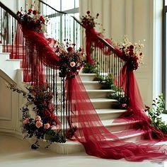 the stairs are decorated with red ribbons and flowers