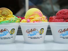 three ice cream cups with different flavors in them