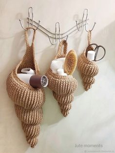 there are two baskets hanging on the wall with hair products in them and one is holding a brush