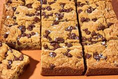 chocolate chip cookie bars cut into squares on an orange surface