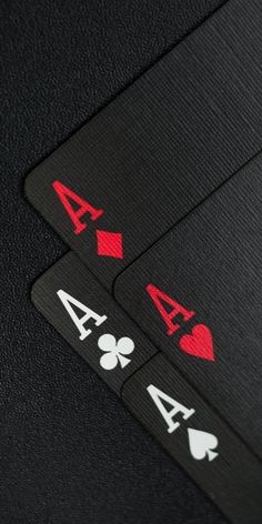 four playing cards with hearts and spades on them