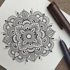 an image of a flower drawn on paper with a fountain pen and some other items