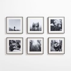 black and white photo frames arranged in the shape of a christmas tree on a wall