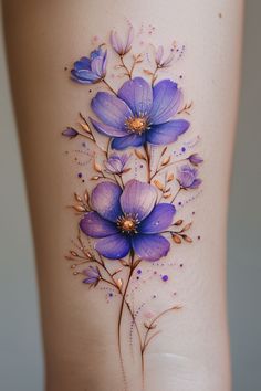 a tattoo with blue flowers on the side