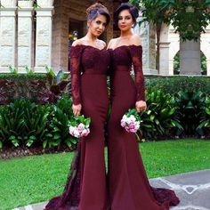 two women standing next to each other wearing long sleeves and dresses with lace on them