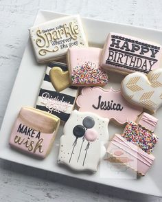 some decorated cookies are on a plate with the words happy birthday written on them,