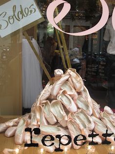 there is a sign that says shoes on display in front of a storefront window