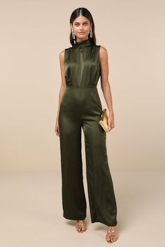 You'll feel like total royalty in the Lulus Classic Elegance Olive Green Satin Sleeveless Mock Neck Jumpsuit! Luxe woven satin shapes this chic jumpsuit that has a mock neckline and a sleeveless bodice with gathered fabric detailing. Fitted waist tops wide legs that end at ankle-length hems. Keyhole opening and double button closure at back. Hidden back zipper/clasp. Fit: This garment fits true to size. Length: Floor length. Size medium measures 61.25" from shoulder to hem. Inseam: 32.25 Front R Winter Wedding Guest Jumpsuit, Jumpsuits For Wedding Guest, Winter Cocktail Attire For Women, Best Woman In Wedding Outfit, Green Jumpsuit Outfit Classy, Mba Graduation Outfit, Queer Wedding Guest Outfit, Wedding Officiant Outfit, Officiant Outfit Female