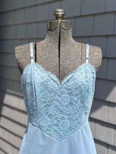 Vintage Vanity Fair Light Blue Nylon Tricot Slip Dress Lace Bodice & Trim Size 36 Midcentury Beautiful Midcentury slip dress in a gorgeous light blue color. Floral lace bodice and bottom trim. Adjustable straps. Inner tag is marked "Vanity Fair" & "Made in USA". Also marked "TRICOT ALL NYLON", "Exclusion of Decorative if Any", & "Size 36".  Please note that vintage sizes differ from modern sizing so please read measurements.  Approximate measurements as follows: Shoulder to Hem - 39 inches Bust/Chest - 30 inches (15 inches, flat) Hem/Sweep - 25.5 inches In great condition with no noticeable flaws apart from a small mark on front of dress, as pictured. Please see all photos. Slip Dress Lace, Vintage Vanity Fair, Lace Trim Dress, Lace Slip Dress, Vintage Vanity, Lace Bodice, Light Blue Color, Dress Lace, Vanity Fair