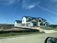 a large white house sitting on the side of a road