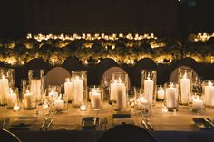 a long table is set with candles and place settings for the dinner guests to enjoy