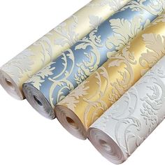 four rolls of wallpaper in different colors