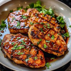 grilled chicken with sauce and green vegetables on a plate