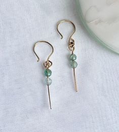 These beautiful and dainty 14k gold filled dangle earrings, with the blue aqua gemstones, are a unique and modern must have piece of jewelry. They will complement any outfit. These earrings would make a beautiful bridesmaids gifts, or a wonderful girlfriend gift, or maybe a self gift to add to your own jewelry collection. 14k gold filled AA Ocean Apatite gemstone Your earrings will be sent to you gift wrapped and in a gift pouch. Dainty Wire Wrapped Earrings For Everyday, Dainty Wire Wrapped Everyday Earrings, Dainty Handmade Briolette Earrings, Dainty Adjustable Gemstone Earrings, Dainty Natural Stone Dangle Earrings, Dainty Dangle Earrings, Aqua Gemstone, Self Gift, Blue Gemstone Earrings