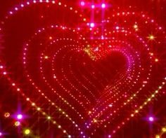 a red heart is surrounded by bright lights