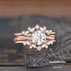 a close up of a diamond ring on a rock