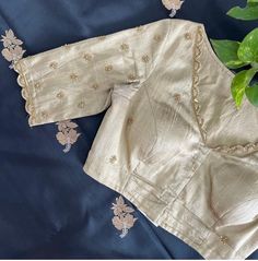 Hand embroidered ready made saree blouse / crop top/stitched saree blouse usa / white saree blouse/modern blouse/zardosi blouse/cream saree blouse/ pure silk blouse/ maggam work blouse        It is very true that a perfect blouse is the one which makes your saree look stand out !! If you find one of such a style that you have been wanting to have then dont let it go !! we carry such unique trending blouses that instantly add a stylish look to any saree !!      Here is a beautiful Hand embroidered zardosi work saree blouse in beige color that has V neck design front and back  emblished with gold and antique scallop embroidered on neck sleeves  front and back as shown!! Runs with any self or contrast color saree ! Please message us for any color / size customization !!  Fabric : pure raw sil Cream Color Blouse Maggam Work Designs, Cream Color Blouse Design, White Silk Saree Blouse Designs, Scallop Embroidery Blouse, Cream Color Maggam Work Blouse, Blouse Sleeve Embroidery Designs, Maggam Work Back Neck Designs, Navy Blue Saree Blouse Combination, Elegant Cotton Silk Blouse Piece With Dori Work