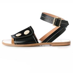 Pierrette Flat Sandals in Black Black Leather Flat Toe Ring Sandals, Ladies Leather Sandals, Chic Black T-strap Sandals With Buckle Closure, Black T-strap Sandals With Flat Leather Sole, Flat Leather Sandals, Leather Slides With Adjustable Strap, Flat Shape, Womens Black Flats, Black Sandals Flat, Ankle Strap Sandals Flat