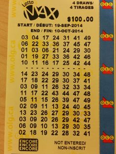 a yellow ticket with numbers on it sitting on a table