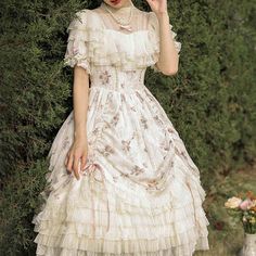 A classic dress and embroidered bonnet for a beautiful Western queen. A gorgeous item that combines pale pink roses and a geometric checkered pattern. The chest and hem are decorated with ruffles that have a strong presence. She is an elegant young lady who is as pretty as a flower. 
 
 
 
 Item 
 
 One Piece 
 Bonnet 
 
 
 Size 
 
 One Piece 
 
 S size 
 
 Length: 103cm 
 Shoulder width: 34.5cm 
 Bust: 88cm 
 Waist: 72cm 
 Sleeve length: 24cm 
 
 M size 
 
 Length: 105cm 
 Shoulder width: 35.5c Spring Princesscore Dresses With Ruffles, Princesscore Dresses With Ruffles For Spring, Summer Princesscore Dress With Lace Trim, White Fitted Princesscore Dress, Fitted White Princesscore Dress, Spring Princesscore Dress With Lace Trim, Princesscore Dresses With Lace Trim For Spring, Cottagecore Dresses With Ruffles For Garden Party, Vintage Square Neck Dress With Ruffles For Garden Party