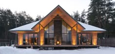 a house that is lit up in the snow