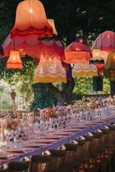 a long table with many different colored lights hanging from it