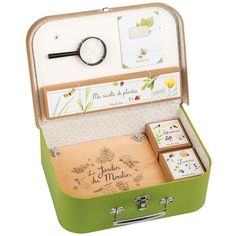 Age: 6+ Discover the natural world of Le Jardin du Moulin! Preserve delicate flowers, chart new paths and explore the outdoors with the entire collection!This Botanist Case includes one Flower Press, a Magnifying Glass, one Notebook and three whimsical boxes to preserve tiny treasures! Packaged in a tan and green case, perfect for toting a botanical collection. Size: 12"x8.5"x3.5" Cardboard Suitcase, The Botanist, Steam Toys, Cute Suitcases, Flower Press, Outdoor Gifts, Green Cases, Botanical Collection, Cadeau Diy