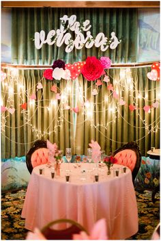 a table with two chairs and a sign that says we are married