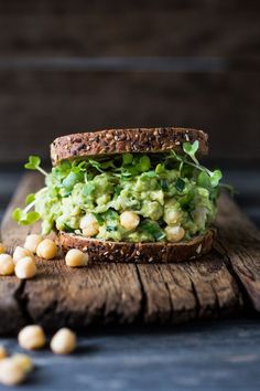 a sandwich with avocado and chickpeas on it