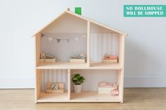 a doll house with furniture and accessories on the floor in front of a white wall