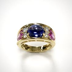 Tanzanite, Pink Sapphire & Diamond Fancy Ring/357 Our job is to capture your unique and beautiful individuality in a design of a perfect ring, such as this stunner featuring the oval cabochon cut tanzanite, that is matched with four side-stone brilliant cut diamonds and two faceted oval cut pink sapphires 1 oval cabochon cut tanzanite 2.97 ct.  2 facetted oval cut pink sapphires = 1.68 ct. /0.83, 0.85 ct./ 4 round brilliant cut diamonds = 0.43 ct. Weight: 9.20 g                                                                                                                                 Material: 18 k yellow gold        Tanzanite 8.90x6.80x5.31 mm  Sapphires 7.00x5.10x2.60 mm, 7.00x5.00x2.53 mm  Diamonds Ø 3.00 mm  Clarity VS2-SI Color G H Fancy Rings, Oval Cabochon, Sapphire Diamond, Perfect Ring, Round Brilliant Cut Diamond, Brilliant Cut Diamond, Pink Sapphire, Rings Statement, Sapphire Ring