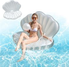 a woman sitting on an inflatable chair floating in the water with balloons attached to it