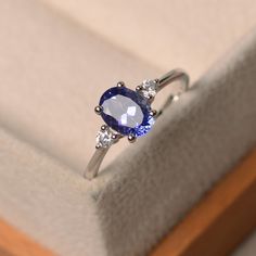 This ring features a 6*8mm oval cut tanzanite and sterling silver finished with rhodium. Customization is available. It is made by hand, and it will take about 7 days to finish the ring after your payment is completed. Main stone: 1.30 ct real tanzanite Metal type: sterling silver finished with rhodium Accent stone: cz Customization is available, I also can make it with 14k solid gold (white or yellow or rose) and diamond accent stone, just feel free to contact me. Any question, just let me know Luo Jewelry, Classy Engagement Ring, Wedding Rings Art, 14k White Gold Diamond Ring, Tanzanite Engagement Ring, Future Engagement Rings, Gold Diamond Engagement Rings, London Blue Topaz Ring, Unique Diamond Rings