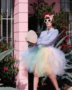 a woman in a blue shirt and white tutu skirt