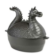 a metal container that has a dragon on it's head in the shape of a bowl