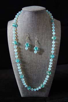 "Wear this pretty piece to a party in your romper or summer dress! This necklace is made of 12mm teal blue faceted rondelle beads with pink floral accents, stationed between 8mm translucent clear faceted rondelles tinted with teal blue in the center, and finished with 2mm silver plastic beads.  It measures approximately 25\" in length and is secured with a plain lobster claw clasp. Your order can be shipped within 2 days." Light Blue Jewelry With Colorful Beads For Party, Party Jewelry In Turquoise Czech Glass, Turquoise Spacer Beads Jewelry For Party, Party Turquoise Beaded Necklaces With Faceted Beads, Turquoise Czech Glass Jewelry For Party, Elegant Light Blue Jewelry With Large Beads, Turquoise Czech Glass Party Jewelry, Turquoise Faceted Beads Necklaces For Party, Party Turquoise Faceted Beaded Necklaces