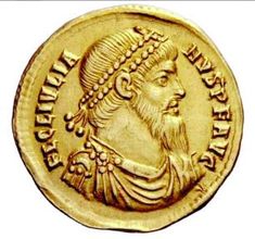 an ancient gold coin with a man's head and beard on the reverse side