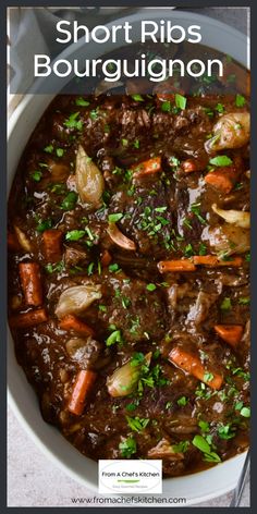 a white bowl filled with beef and carrots on top of a wooden cutting board