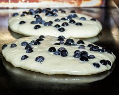 two uncooked cookies with blueberries on them