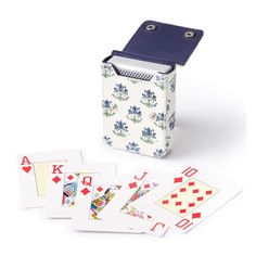 four playing cards are in front of a lighter and card game set on a white background