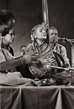 an old black and white photo of people playing musical instruments in front of microphones