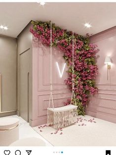 a bathroom with pink walls and flowers growing on the wall, along with a white toilet