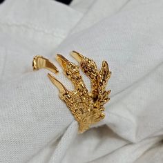 Show off your edgy style with our fabulous Gold Dragon Claw Ring! Designed meticulously to portray dragon claws, this unique piece of gothic jewelry is sure to make an impression. This extraordinary gold-toned rim is an open ring, making it fully adjustable to fit anyone. Ideal for those who love punk or biker aesthetics, this ring can also make a marvelous gift. Flaunt your unique sense of style with this intriguing Dragon Wrap Ring! Product Description - Material :- 925 Sterling Silver/Alloy S Gothic Dragon, Dragon Claws, Faberge Jewelry, Claw Ring, Dragon Claw, Dragon Ring, Ring Inspo, Gold Dragon, Vintage Style Rings