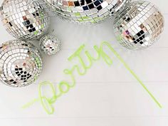 several disco balls with the word happy spelled out in front of them on a white background