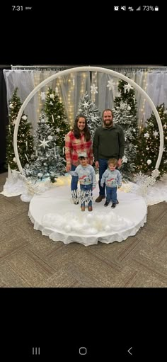 two people standing in front of a christmas display