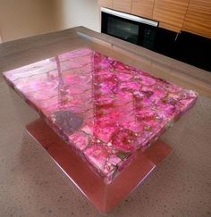 a glass table with pink flowers on it